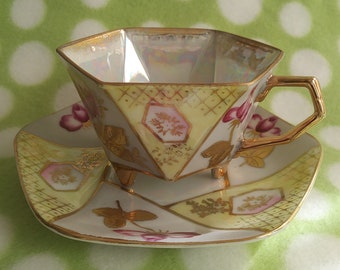 Vintage cup and saucer, hexagonal shaped, 3 footed, iridescent.