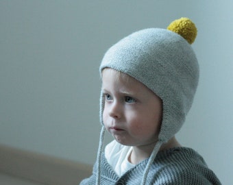 Simple knitted toddler hat with pompon in soft alpaca blend yarn, many colors available.