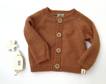 Warm and soft hand knitted baby cardigan for baby girl or baby boy available in many colors