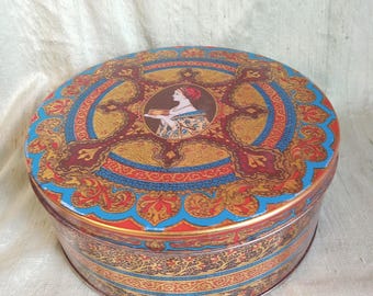 Gold and blue HOSTESS FRUIT CAKE metal tin / vintage female portrait tin container