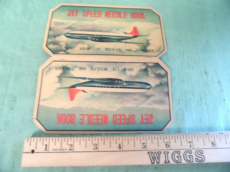 May include: Two vintage needle books with a jet plane design. The books are titled "Jet Speed Needle Book" and feature the text "115 Best Gold Eye Needles and Threader".