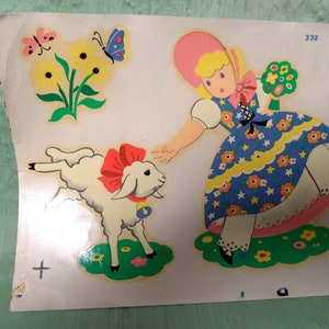 May include: A vintage illustration of a girl in a pink and blue dress holding a bouquet of flowers and a white lamb with a red bow. The illustration is on a white background with a green border.