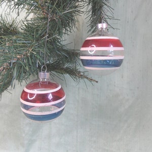 Two clear, unsilvered striped vintage glass Christmas tree ornaments / red, white and blue