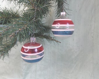 Two clear, unsilvered striped vintage glass Christmas tree ornaments / red, white and blue