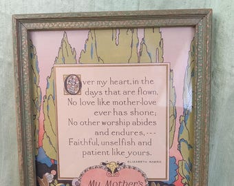 Puede incluir: Una impresión enmarcada con un poema sobre el amor de una madre. El marco verde tiene un borde decorativo. La impresión presenta un diseño floral con un emblema en forma de corazón que dice "My Mother's Love". El fondo tiene una combinación de colores pastel.