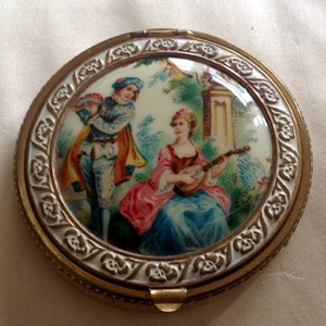 Gorgeous cream mid century powder compact with enamel top featuring a medievalist scene