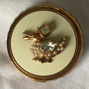 Small 1950&#39;s Evans tap sift powder compact, cream enamel with a crystal Rhinestone, with the design of a duck