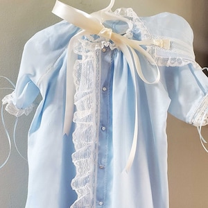 Blue Swiss batiste lace front ruffle heirloom baby gown and cap. Features French Valenciennes ivory lace, ivory hand embroidery, satin ribbon, and mother of pearl buttons.