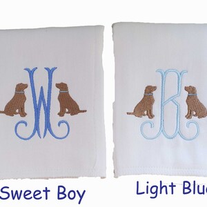 Cotton diaper burp cloth embroidered with a single initials framed with two dogs. Colors can be customized for a baby boy or girl. Pictures show the difference in blue initial colors.