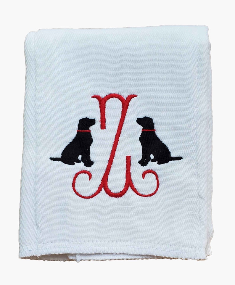 Cotton diaper burp cloth embroidered with a single initials framed with two dogs. Colors can be customized for a baby boy or girl. Red thread color initial and dog collars.