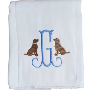 Cotton diaper burp cloth embroidered with a single initials framed with two dogs. Colors can be customized for a baby boy or girl.