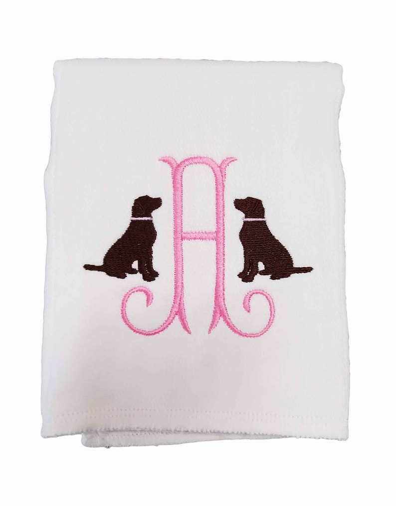 Cotton diaper burp cloth embroidered with a single initials framed with two dogs. Colors can be customized for a baby boy or girl.