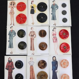 May include: A collection of vintage buttons in various colors and designs, displayed on cards with fashion illustrations. The buttons include red, black, brown, and peach tones, with sizes ranging from small to large.