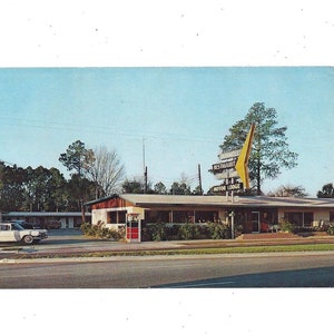 Pocztówka z 1961 r. przedstawiająca restaurację Bunnell Restaurant & Motor Lodge Motel w Bunnell na Florydzie, wysłana ze znaczkiem o wartości 3 centów, pamiątka z podróży