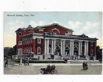 May include: A vintage postcard showing a red brick building with white columns and a large entrance. The building is labelled "Memorial Building, Lima, Ohio".
