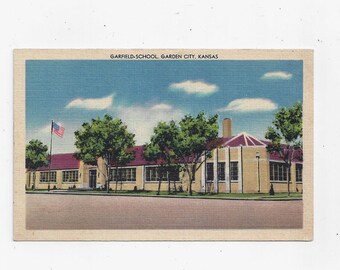 May include: A vintage postcard showing Garfield School in Garden City, Kansas. The school building is a single-storey structure with a red roof and yellow brick walls. There are trees in front of the building and an American flag flying on a pole.