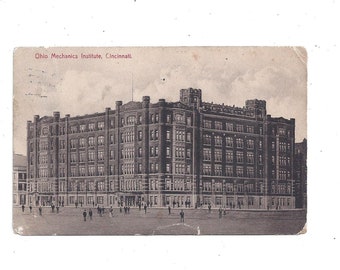 May include: A black and white postcard showing the Ohio Mechanics Institute in Cincinnati. The building is a large, multi-storey structure with numerous windows.