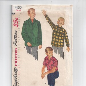 May include: Vintage Simplicity sewing pattern for boys' shirts. The pattern is for sizes 4 and includes three different styles: a green solid shirt, a plaid shirt, and a red and white checkered shirt. The pattern is printed on a white background with black text. The pattern is dated 1958 and costs 35 cents.