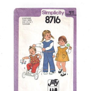 May include: Simplicity sewing pattern number 8716 for a toddler's outfit. The pattern includes three different styles: a blue and white striped dress, a yellow and brown dress, and a red and white striped outfit. The pattern is labeled "Jiffy" and includes 2-3 main pattern pieces.