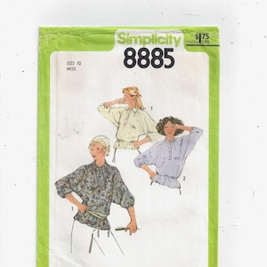 May include: Simplicity sewing pattern number 8885 for a blouse. The pattern shows three different styles of blouses with long sleeves and a gathered waist. The pattern is for size 10 miss.