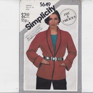 May include: Simplicity sewing pattern number 5649 for a red jacket with black trim. The pattern is for sizes 14-16 and is labeled "Fast & Fabulous".