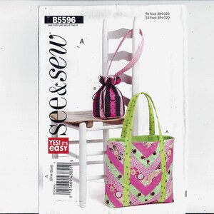 May include: A sewing pattern for two bags, a pink and black drawstring bag and a pink and green tote bag. The pattern is called "see & sew" and is labeled B5596.