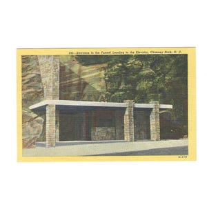 May include: A vintage postcard depicting the entrance to the tunnel leading to the elevator at Chimney Rock, N.C. The image shows a stone structure with a covered walkway and the word "ELEVATOR".