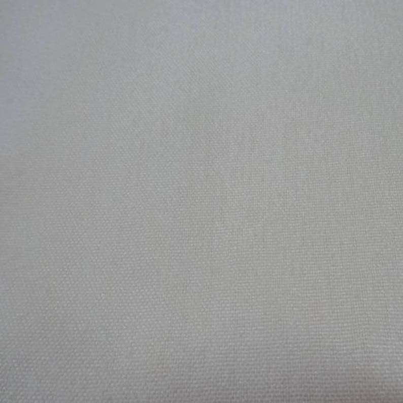 May include: A plain white fabric with a subtle woven texture.