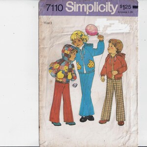 May include: Vintage Simplicity sewing pattern 7110, with illustrations of children's clothing. The cover shows three children in colourful outfits: a hooded jacket, a blue tracksuit, and a red jacket with plaid trousers. The pattern is for size 3.