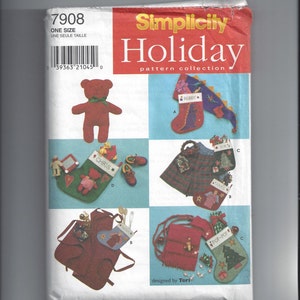 May include: A Simplicity Holiday pattern collection featuring various Christmas-themed sewing projects. The cover displays a red teddy bear, stockings, aprons, and a fringed bag. The text "Holiday" is in large, bold letters.