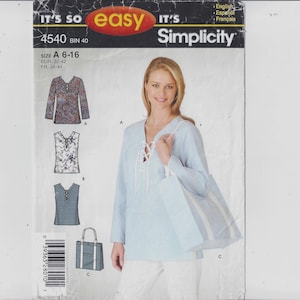 May include: Simplicity sewing pattern 4540, size A 6-16. The pattern includes designs for a tunic top and tote bag. The model is wearing a light blue tunic with a lace-up neckline and carrying a matching tote bag.