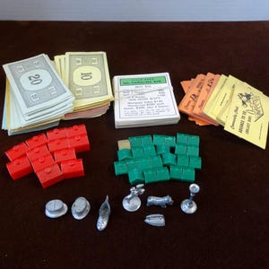 1960s Monopoly Board Game Pieces, 12 Hotels, 25 Houses (1 Wood), 7 Place Markers, Property Cards, Play Money, Community Chest, Replace Clue