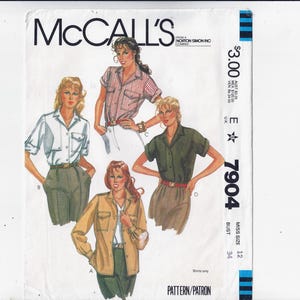 May include: McCall's sewing pattern featuring shirt designs. The cover shows illustrations of women wearing different shirt styles, including a white shirt, a striped shirt, and a green shirt. The pattern number is 7904.