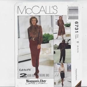 May include: McCall's sewing pattern number 6731 for sizes 8, 10, and 12. The pattern is for a woman's dress with a long skirt and a fitted bodice. The pattern is part of the Woman's Day Collection.