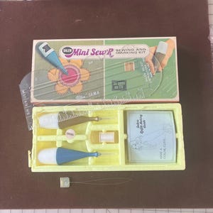 May include: A vintage Salem Mini Sew'R sewing and marking kit. The kit includes a clear plastic ruler, sewing tools, thread, and a guide. The box is green and white with the text "As Seen on TV".