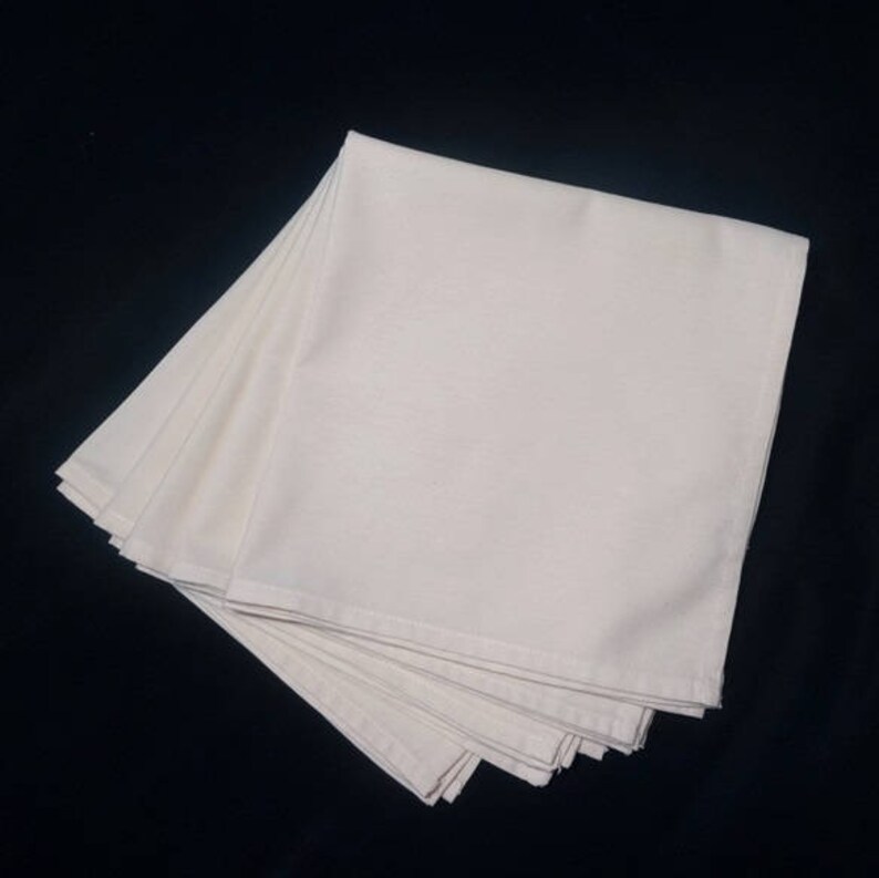 May include: A stack of 10 white cotton dish towels folded neatly. The towels are soft and absorbent, perfect for everyday use.