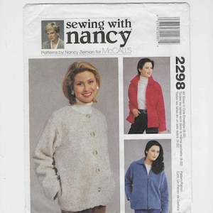 Puede incluir: Un sobre de patrón de costura con tres diseños de chaqueta. La imagen principal muestra a una mujer con una chaqueta abotonada de color crema. El sobre incluye el texto "sewing with nancy" y "Patterns by Nancy Zieman for McCall's."