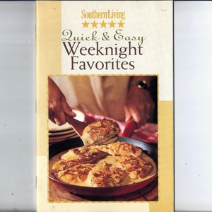 May include: A cookbook cover with a yellow background and the title "Quick & Easy Weeknight Favorites" in brown text. The cover features a photo of a hand using a wooden spoon to serve chicken in a skillet.