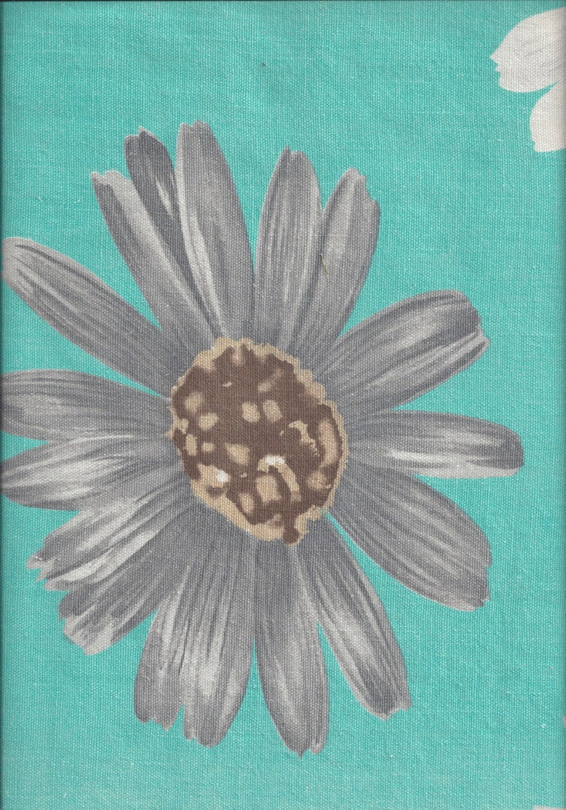 May include: A large gray daisy with a brown center on a turquoise background.