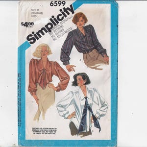 May include: Simplicity sewing pattern number 6599 for a blouse with a bow tie. The pattern includes three different styles of blouses with long sleeves. The pattern is for misses' sizes.