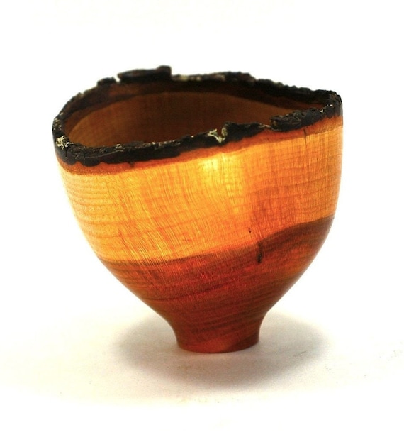 A real woodturner's signed, natural-edge cherry bowl from the Pacific Northwest — the kind of one-of-a-kind object that looks like it belongs in a gallery, not a warehouse.