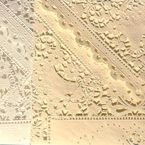 To the left is the original bright white - all out. The center is the new batch of 20 year-old vintage doilies which are a warm white. On the right is a rich cream in the same style.