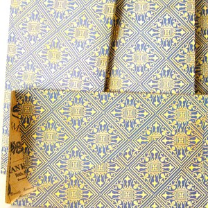 May include: Three blue and gold patterned boxes with a label on the bottom box that reads "ANK Fifth Ave. New York.  Dancy Evening Lillian"