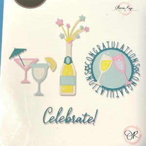May include: A Sizzix Thinlits die set featuring 12 metal cutting dies for paper crafting. The package displays illustrations of a champagne bottle with stars, two cocktail glasses, and a circular design with two glasses and the text CONGRATULATIONS.