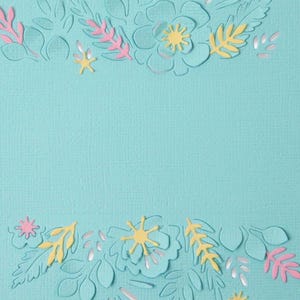 May include: A textured light blue cardstock paper featuring die-cut floral and leaf patterns at the top and bottom edges. The cutouts reveal layers of soft pink and pale yellow paper underneath, creating a layered botanical design on the surface.