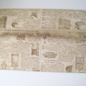 May include: A folded paper envelope with a vintage newspaper print design. The print features faded text and illustrations of antique items. The envelope is beige and has a slightly distressed appearance, suggesting an aged aesthetic.