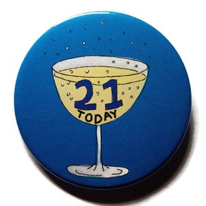 May include: A blue round button with a yellow champagne glass with the number 21 in blue and the word "TODAY" in black.