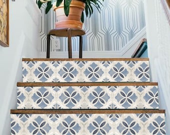 May include: A staircase featuring four steps with decorative riser decals. Each riser displays a repeating pattern of blue and cream-colored floral motifs. The wooden treads are dark brown, and the staircase is framed by white walls and a wooden handrail.