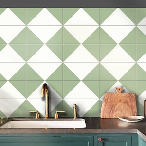 May include: A kitchen sink with a green cabinet underneath. The backsplash is a green and white diamond pattern.