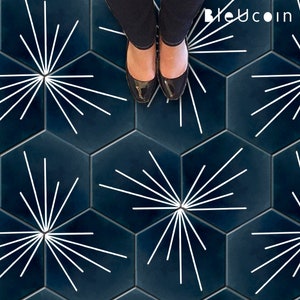 Könnte beinhalten: Ein dunkelblauer sechseckiger Fliesenboden mit weißen Sternburst-Designs. Der Boden ist aus Keramikfliesen und hat eine glänzende Oberfläche.